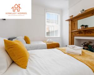 a bedroom with three beds and a fireplace at Supersized 5bed - Free parking - 8 beds - Anfield - By Hinkley Homes Short Lets & Serviced Accommodation in Liverpool