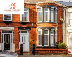 a brick house with a white door and windows at Supersized 5bed - Free parking - 8 beds - Anfield - By Hinkley Homes Short Lets & Serviced Accommodation in Liverpool