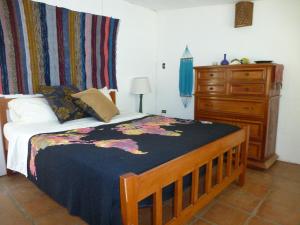 a bedroom with a bed with a dresser and a dresser at Alchemy on the Lake in La Laguna