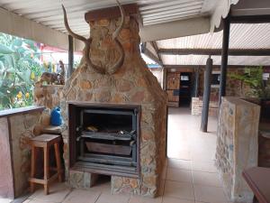 a stone fireplace with a stove inside of it at KHAYA LANGA Guest House & Contractors Accommodation in Machadodorp