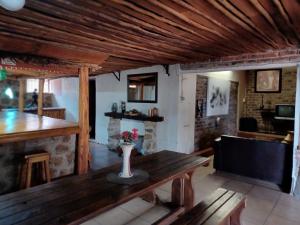 a living room with a wooden table and a fireplace at KHAYA LANGA Guest House & Contractors Accommodation in Machadodorp