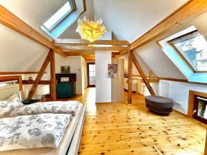 a bedroom with a bed and a ceiling with skylights at Historisches Retro Loft 120m2 + Garten & Seenähe in Schwielowsee