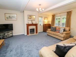 a living room with a couch and a fireplace at Lower Cowden Farm in Bakewell