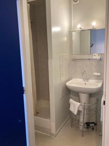 a white bathroom with a sink and a shower at Le Jorjane in Choranche