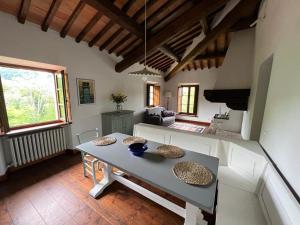 a living room with a table and a couch at Villa Casa di Pietra en el norte de Lucca, Toscana in Camporgiano