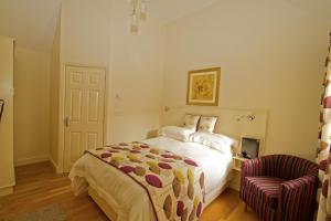 a bedroom with a bed and a chair at Meals Farm - Courtyard Room in North Somercotes