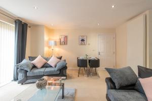 a living room with a couch and a table at Apartment 8 in Worksop