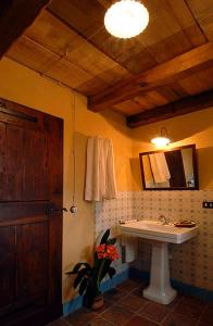 a bathroom with a sink and a mirror at Dimora Storico Romantica Il Sole E La Luna in Cerretto Langhe