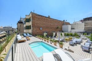 a rooftop deck with a swimming pool on a building at Azur Real Hotel Boutique & Spa in Cordoba