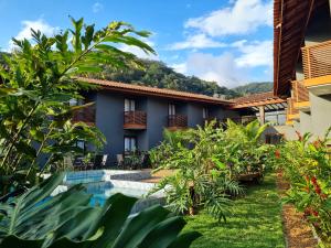 a view of a resort with a swimming pool at Pousada Vila Ipuan in Pauba