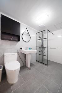 a bathroom with a toilet and a sink at Pension Haneul Tari in Jeju