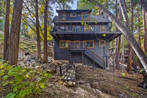 a tree house in the woods with a deck at Pet-Friendly Retreat with Game Room and Fire Pit! in Lake Arrowhead