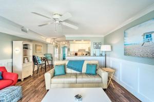 a living room with a couch and a table at Bright Carolina Beach Condo - Walk to Shore! in Carolina Beach