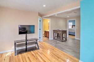 a living room with a television and a table at Remodeled Harrison Retreat Less Than 6 Mi to Town! in Harrison