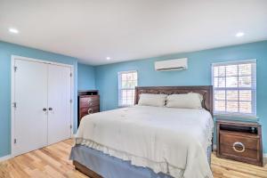 a bedroom with blue walls and a large bed at Remodeled Harrison Retreat Less Than 6 Mi to Town! in Harrison