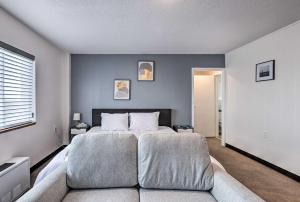 a bedroom with a large bed and a couch at Airy Apt Situated in the Coosa River Area! in Gadsden