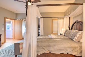 a bedroom with a bed with a canopy at Lakefront Romulus Retreat with Private Dock! in Romulus