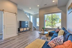 a living room with a blue couch and a tv at Commerce City Townhome about 6 Mi to Dtwn Denver! in Thornton