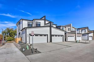 a large house with two garage doors in a driveway at Commerce City Townhome about 6 Mi to Dtwn Denver! in Thornton