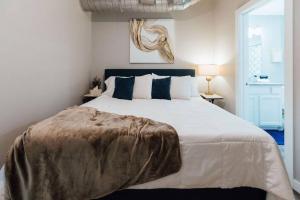 a bedroom with a large bed with a blanket on it at The Sanctuary Company Johnson City in Johnson City