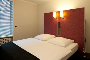 Postel nebo postele na pokoji v ubytování Hotel Topas Frankfurt City