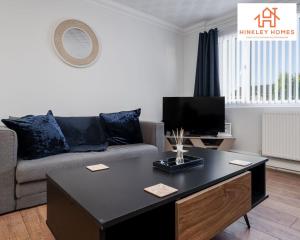 a living room with a couch and a table at Spacious 3 bedroom house with wifi and car parking By Hinkley Homes Short Lets & Serviced Accommodation in Waterloo