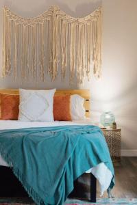 a bedroom with a bed with a blue blanket on it at The Sanctuary Company Johnson City in Johnson City