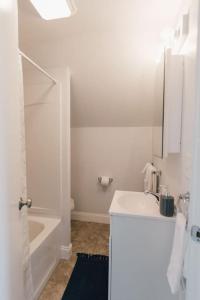 a white bathroom with a sink and a shower at Charming Apt with chic decor Superhost w 5 Stars in Bristol +10 photos