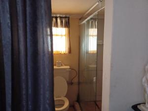 a bathroom with a toilet and a glass shower at KHAYA LANGA Guest House & Contractors Accommodation in Machadodorp +75 photos