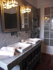 a bathroom with two white sinks and a mirror at La Mulonniere in Saint-Sébastien-sur-Loire