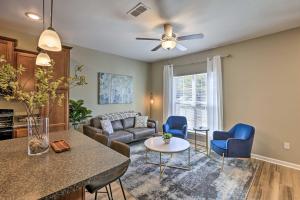 a living room with a couch and a table at Ideally Located and Elegant Condo with Balcony! in Tallahassee