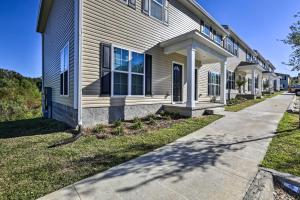 a white house with a sidewalk in front of it at Ideally Located and Elegant Condo with Balcony! in Tallahassee