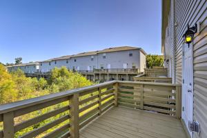 a balcony with a wooden railing and a building at Airy Tallahassee Condo about 5 Mi to Downtown! in Tallahassee