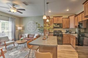 a kitchen and living room with a table and chairs at Airy Tallahassee Condo about 5 Mi to Downtown! in Tallahassee