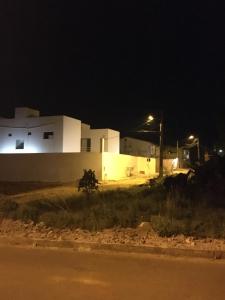 a house at night with lights on the side of the road at RDS Hospedagem in Itacaré