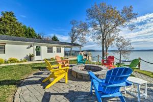 a group of colorful chairs sitting around a fire pit at New Concord House with Lake Access! in New Concord