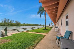 a house with a patio with a view of the water at Picturesque Waterfront Studio in Clearwater Beach