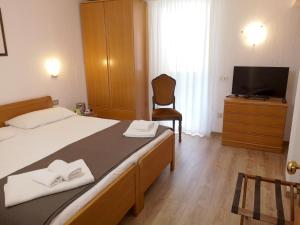 Postel nebo postele na pokoji v ubytování Hotel Villa Milano