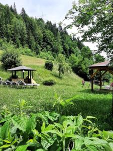 a park with a gazebo and chairs in a field at Landhof Kreuzsalgut in Wagrain