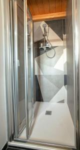 a shower with a glass door in a bathroom at FORESTERIA LOMBARDA BED and BIKE CREMONA in Crotta dʼAdda +22 photos
