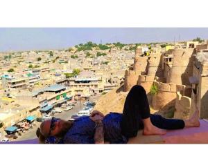 a man laying on the ledge of a building at Hotel Desert in Jaisalmer