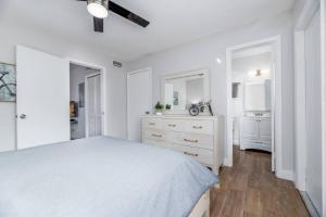 a white bedroom with a bed and a dresser at The Guesthouse 2 - Wilton Manors in Fort Lauderdale