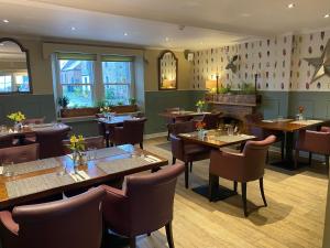 a restaurant with tables and chairs in a room at Allanton Inn in Allanton