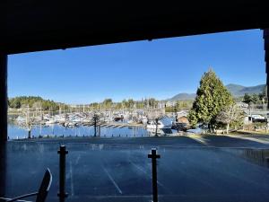 a large window with a view of a parking lot at Marina View On The Harbour in Ucluelet