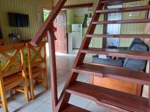 a wooden staircase in a room with a kitchen at Paso del.Sol in Piriápolis