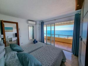 a bedroom with two beds and a view of the ocean at Spectacular Sea Views Benalmádena in Benalmádena
