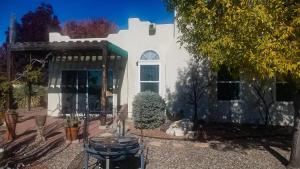 a white house with a dog sitting in front of it at The perfect place . . . here it is! in Las Cruces