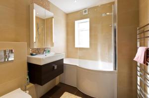 a bathroom with a sink and a shower and a toilet at Leafy Suburban Bed and Breakfast in Northwood