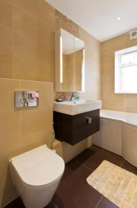 a bathroom with a toilet and a sink at Leafy Suburban Bed and Breakfast in Northwood