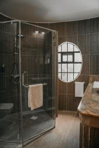 a bathroom with a shower with a glass door at Saab Royale Resort in Kajiado